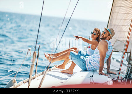 Happy man and woman relaxing on a luxury yacht. Happy couple on cruise. Stock Photo