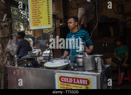 A man selling Lassi, an traditional Indian yoghurt drink, at a street stall in  New Delhi, India. Stock Photo