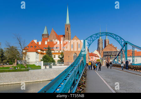 Wroclaw, Lower Silesian province, Poland. Tumski Bridge, leading to the Ostrow Tumski district. Belfries of the Collegiate Church of Holy Cross. Stock Photo