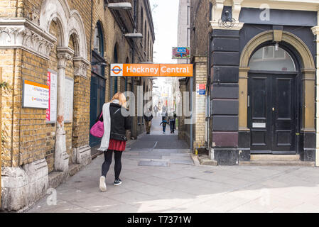 Hackney, London, England, UK - Entrance of Hackney Central London Overground station on the North London Line with commuters walking Stock Photo