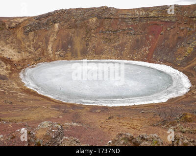 Aerial view of the icy Kerið volcanic crater lake at Iceland Stock Photo