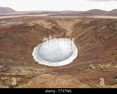 Aerial view of the icy Kerið volcanic crater lake at Iceland Stock Photo