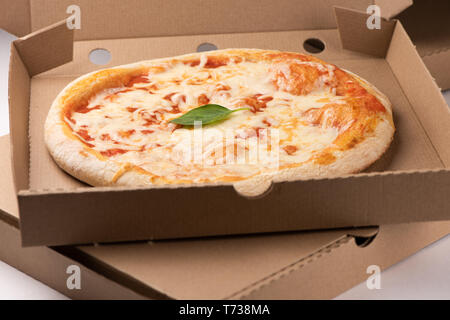 Pizza in a cardboard box close up Stock Photo