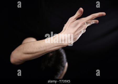 Empty man pointing finger on black background Stock Photo