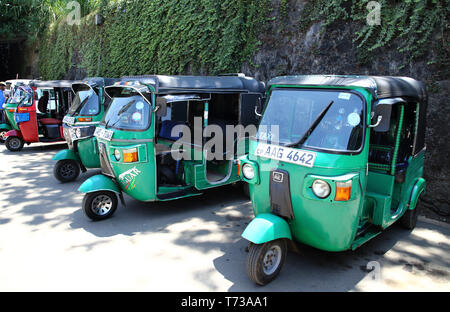 tuk tuk taxi traveling by train through the hill country at nanu-oya station in sri lanka Stock Photo