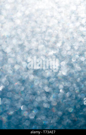 vertical gradient background of bright sunlight shining through a rippled glass pane with blue sky contrast and bokeh Stock Photo