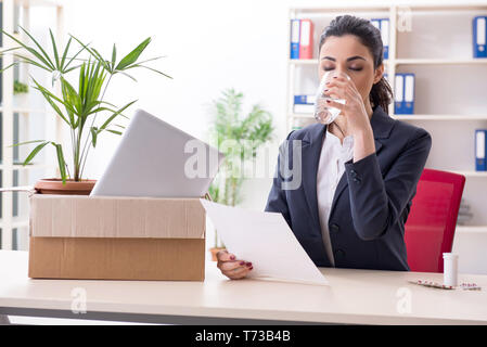 Young female employee being fired from her work Stock Photo