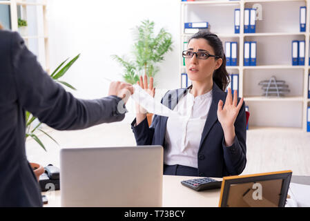 Young female employee being fired from her work Stock Photo