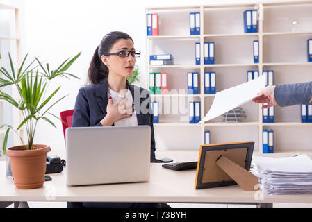 Young female employee being fired from her work Stock Photo