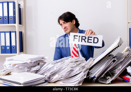 Young businessman employee unhappy with excessive work Stock Photo