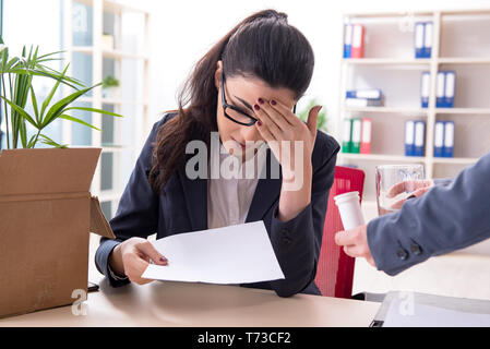 Young female employee being fired from her work Stock Photo