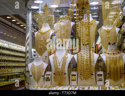 Dubai, UAE - Dec 6, 2018. Gold jewelry in the display window of a jewelleries shop in Dubai Gold Bazaar (Souk). Stock Photo