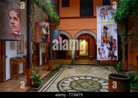 Decorative interior of a Synagoge with artwork displayed and a Star of David on the ground, Jewish Quarter of Cordoba; Cordoba, Spain Stock Photo