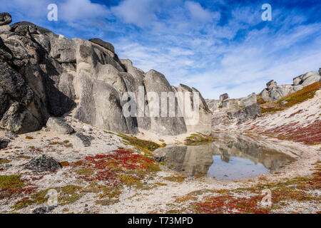 Giant rocks reflect in pond along the Kesugi Ridge Trail, Denali State Park in the autumn, South-central Alaska; Alaska, United States of America Stock Photo