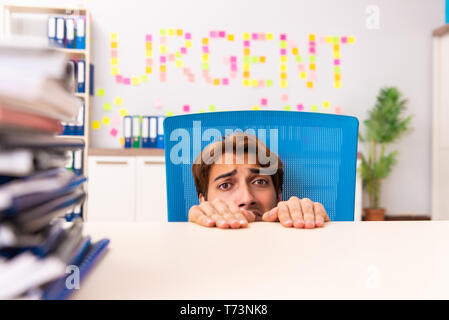 Young employee suffering from excessive work Stock Photo