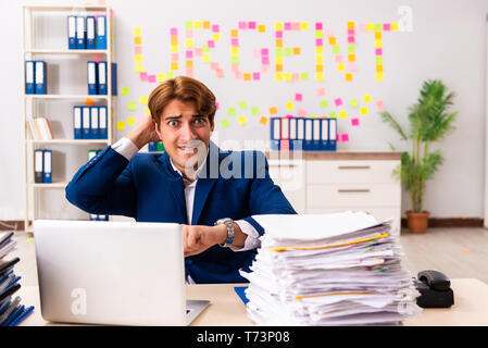 Young employee suffering from excessive work Stock Photo