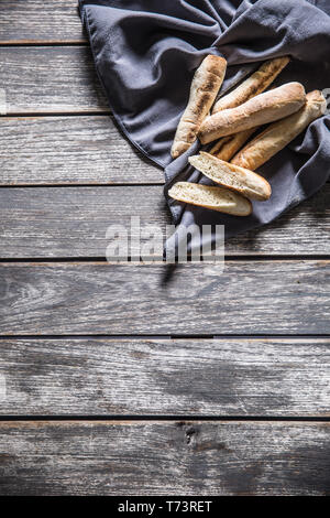 Top of view french mini baguette on tablecloth and wooden table. Stock Photo