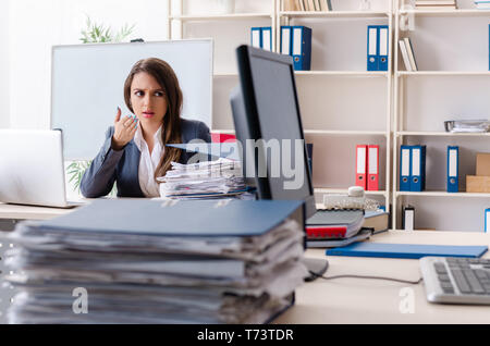 Beautiful female employee unhappy with excessive work Stock Photo