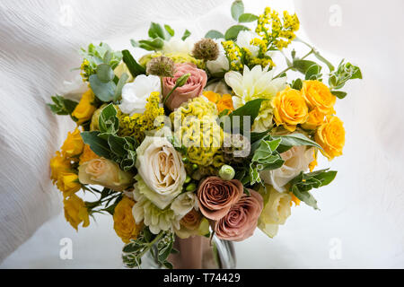 Yellow pink and white roses in the bridal bouquet Stock Photo
