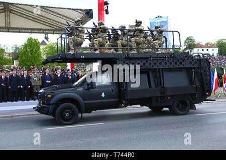 Poland: Tanks, ATVs, SUVs and artillery of Polish Army roll at military parade during celebrations of the constitution. Stock Photo