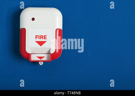 Manual fire alarm pull station on wall indoors Stock Photo
