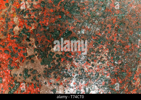 Red & green dried paint etched into concrete surface. Stock Photo