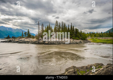 A stormy summers day over the Turnagain Arm as the tide flows out in South-central Alaska; Alaska, United States of America Stock Photo