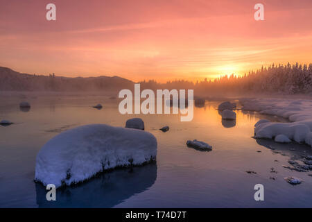 Winter sunset along the shoreline of Mendenhall River, Tongass National Forest; Juneau, Alaska, United States of America Stock Photo