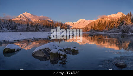 Winter sunset along the shoreline of Mendenhall River, Tongass National Forest; Juneau, Alaska, United States of America Stock Photo