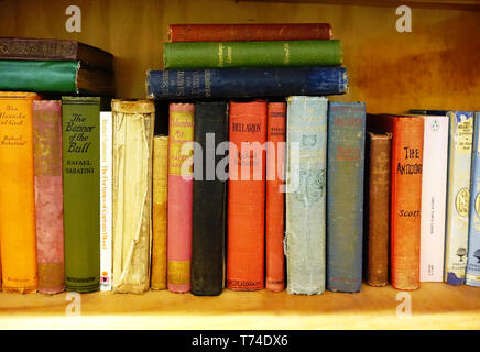 Old cloth bound books on a shelf Stock Photo