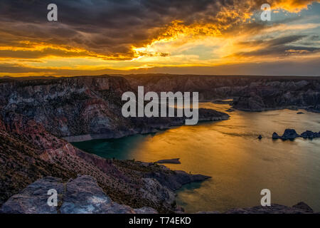 Fiery sunset clouds on a desert lake; San Rafael, Mendoza, Argentina Stock Photo
