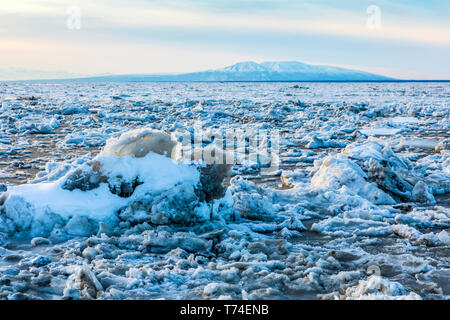 Looking west across the Knik Arm, sea ice in winter choking the Cook Inlet in winter with Mount Susitna (Sleeping Lady) in background photographed ... Stock Photo