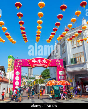 Chinese red lanterns for Chinese New Year celebrations  and tourists at gateway arch entrance to Pagoda Street Chinatown Singapore. Stock Photo