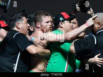 Las Vegas, Nevada, USA. 3rd April, 2019. Canelo Alvarez gets held back during a shoving match with Daniel Jacobs on stage during todays weighs in at the T-Mobile arena in Las Vegas Friday April 3, 2019. The two will fight for the middleweight world championship Saturday on DAZN. Photo by Gene Blevins/ZumaPress Credit: Gene Blevins/ZUMA Wire/Alamy Live News Stock Photo