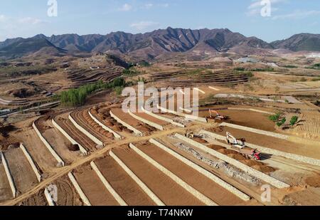 Shijiazhuang. 2nd May, 2019. Aerial photo taken on May 2, 2019 shows workers working at the site of reclamation project on the abandoned mine area at Dahezhuang Village in Wuchong'an Township of Qian'an City, north China's Hebei Province. Local government has devoted to the reclamation and afforestation of mine areas in recent years. Credit: Yang Shiyao/Xinhua/Alamy Live News Stock Photo