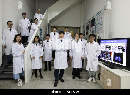 (190504) -- WUHAN, May 4, 2019 (Xinhua) -- Zhou Xin (3rd R, front) and core members of his group pose for a group photo at Wuhan Institute of Physics and Mathematics of Chinese Academy of Sciences in Wuhan, capital of central China's Hubei Province, April 19, 2019. Professor Zhou Xin is the deputy director of Wuhan Institute of Physics and Mathematics of Chinese Academy of Sciences, State Key Laboratory of Magnetic Resonance and Atomic and Molecular Physics, and National Center for Magnetic Resonance in Wuhan. He is interested in ultrasensitive magnetic resonance imaging (MRI) instruments, tec Stock Photo