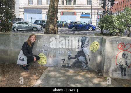 London, UK. 4th May, 2019. A new authentic artwork by Banksy has been covered in Perspex glass against damage at the site where the Extinction Rebellion climate change demonstrators protested and were camped out for more than a week in at Marble Arch. The mural features the slogan “From this moment despair ends and tactics begin” next to a young girl sitting on the ground holding an Extinction Rebellion logo Credit: amer ghazzal/Alamy Live News Stock Photo