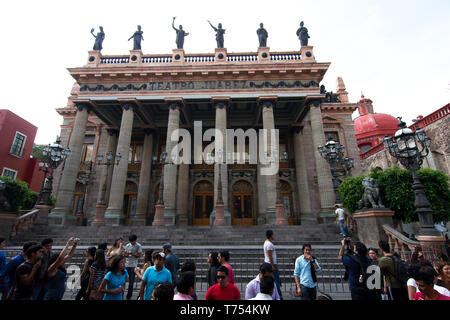 Guanajuato City, Guanajuato, Mexico - 2019: Tourists take pictures in front of Teatro Juárez, a historic theater. Stock Photo