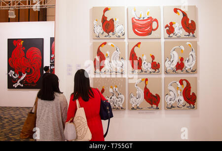 Visitors are seen admiring paintings of Wenas Heriyanto artwork during the Art Moments. Art Moments Jakarta, is an art fair held on May 3 - 5 in Jakarta showcasing over 30 leading local and international galleries. The fair which was opened for the public for two days exhibiting contemporary art works from renowned artists such as Banksy, Christine Ay Tjoe, Handiwirman Saputra, Robert Indiana, Fernando Botero, Ju Ming, Kaws, Marc Quinn and Jean Mitchel Othoniel among others. Stock Photo