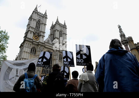 Activist are seen holding placards during the protest. Anti-nuclear activists gathered opposite Westminster Abbey in London to protest against a service of thanksgiving organised by The Royal Navy to mark 50 years of Britain's submarine-based nuclear weapons. Anti-nuclear activists performed a “die-in” outside Westminster Abbey representing the victims of nuclear war. Stock Photo