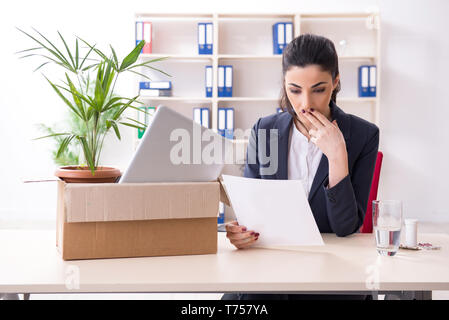 Young female employee being fired from her work Stock Photo