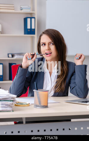 Beautiful female employee unhappy with excessive work Stock Photo