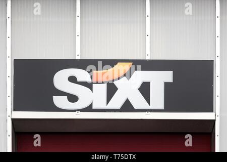 Billund, Denmark - February 20, 2019: Sixt logo on a wall. Sixt is a European multinational car rental company with about 4,000 locations Stock Photo