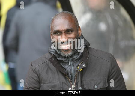 Burslem, Stoke-On-Trent. 27th April, 2019. Macclesfield Town manager Sol Campbell in the dugout at Port Vale's Vale Park. Stock Photo