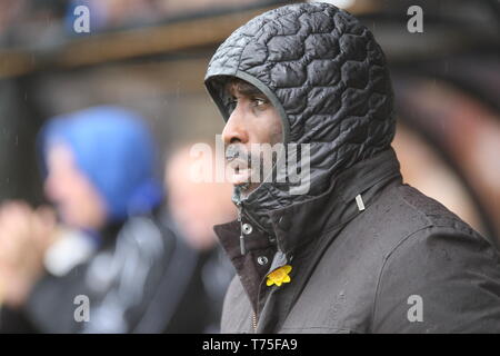 Burslem, Stoke-On-Trent. 27th April, 2019. Macclesfield Town manager Sol Campbell in the dugout at Port Vale's Vale Park. Stock Photo