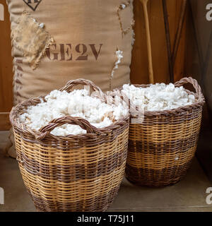 Two antique baskets of raw cotton Stock Photo