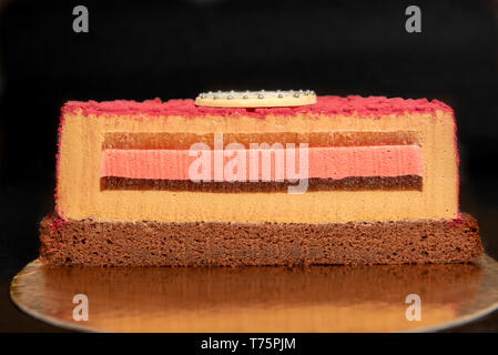 Multilayered cake with four insertions on black background Stock Photo