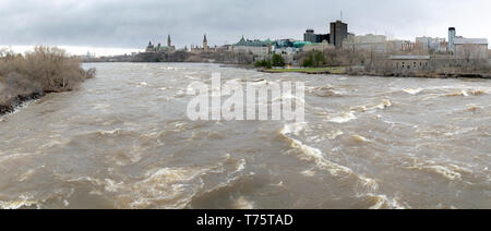 A panoramic view towards Parliament Hill of the historic flooding of the Ottawa River in April 2019, taken from the Portage Bridge in Ottawa, Ontario. Stock Photo