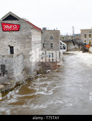 Extreme flooding of the Ottawa River in April 2019 forced Hydro Ottawa floodgates to be opened just above the Mill Street Pub near Chaudiere Falls. Stock Photo