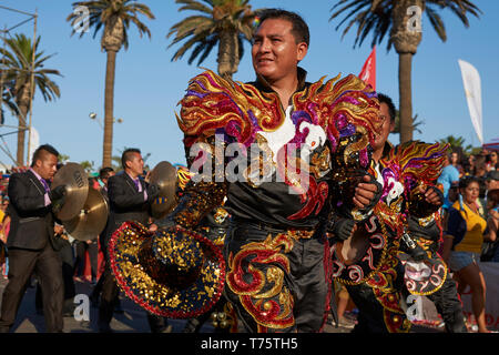 Caporales dancer in ornate costume performing at the annual Carnaval Andino con la Fuerza del Sol in Arica, Chile. Stock Photo